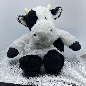 A Microwavable Bean Bag Cow Plush Stuffed Animal Weighted Heating Pad